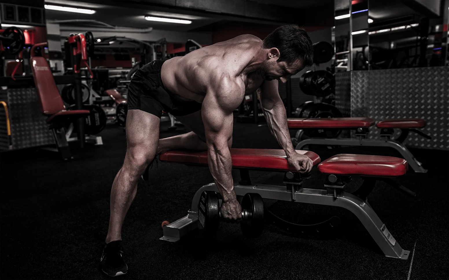 Jonny lifting a loaded trap bar in a gym